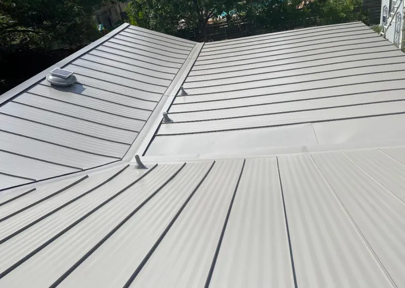 Solar attic fan installed on a metal roof for Roof Ventilation in Rittman
